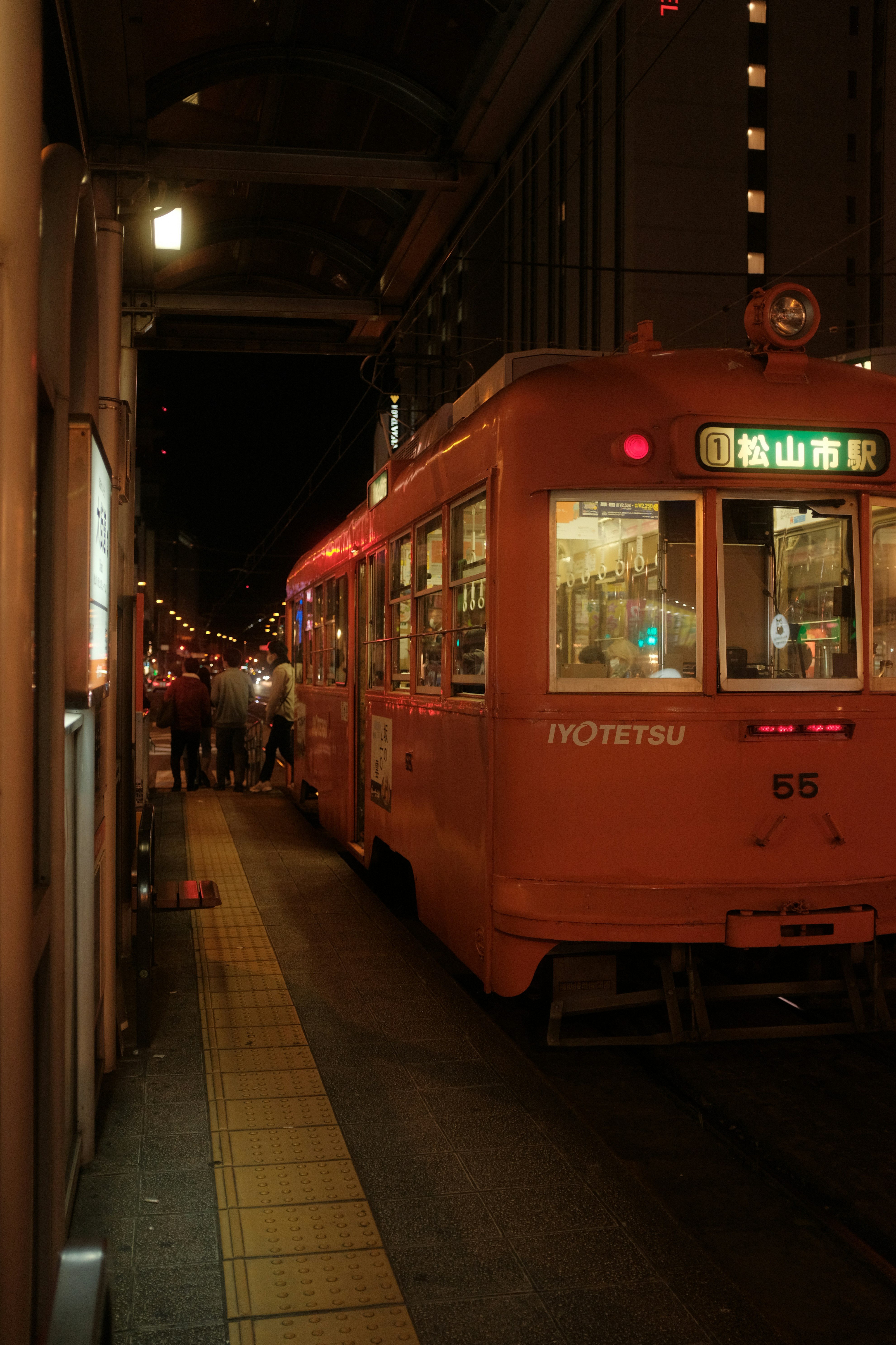 red tram on the street during night time